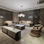 Cream Curved Leather Sofa with Dark Green Fan-Stitched Panels and Laced Edge Details